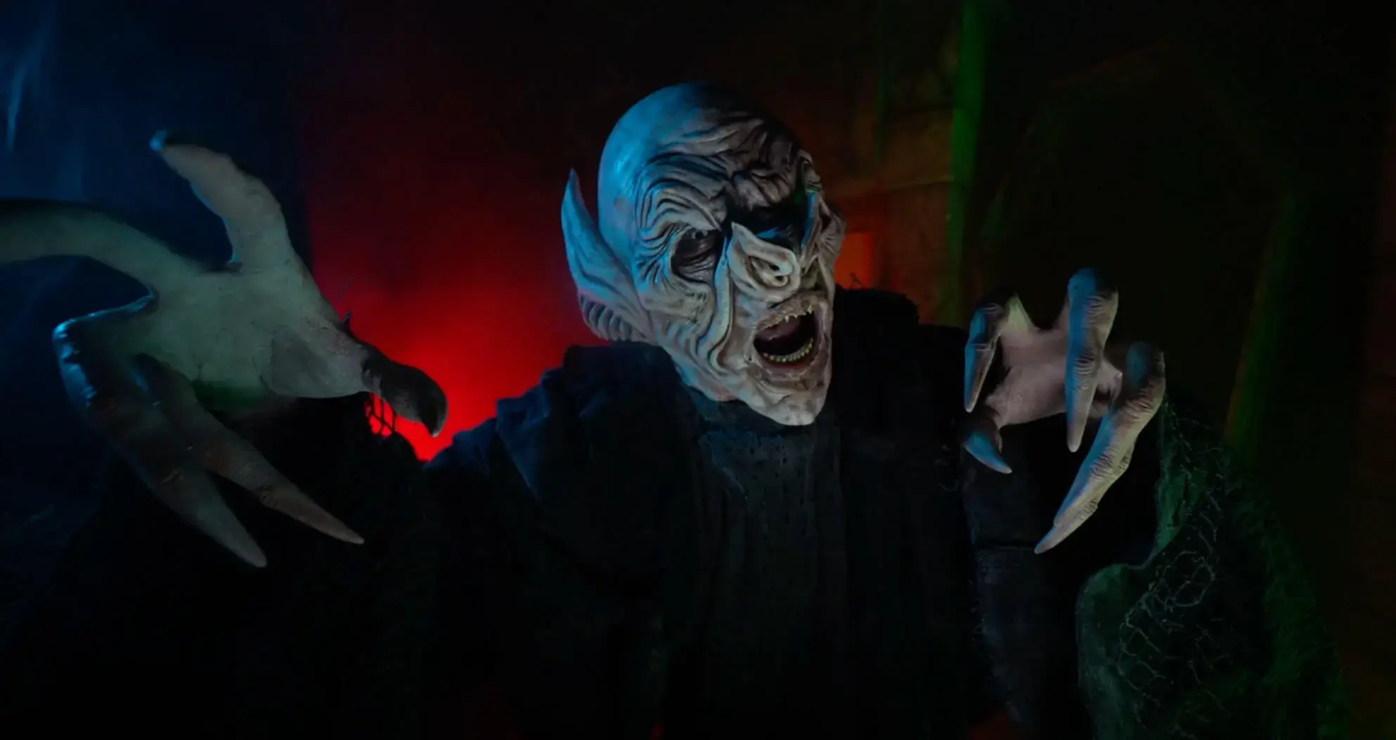 Vampire with stretched hands at SF haunted house entrance
