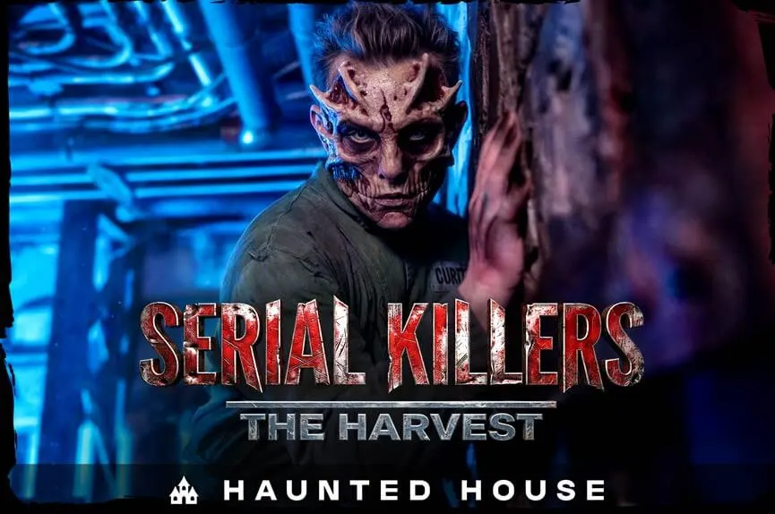 A horrifying figure with a mutated, bone-exposed face and a green jumpsuit stares menacingly in a dark, blue-lit industrial corridor. The text reads "Serial Killers: The Harvest. Haunted House."